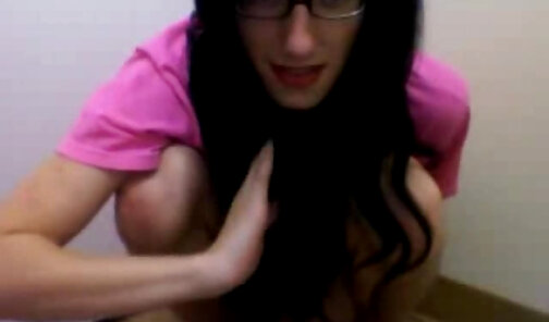 Nerdy tgirl wearing glasses jerks her long cock and spreads her little ass