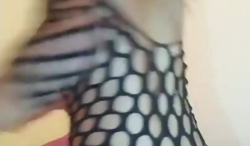Sexy fishnet babe pleasures herself