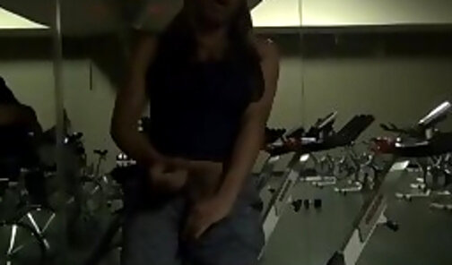 Working out in the gym, stroking her big cock, and blowing a load