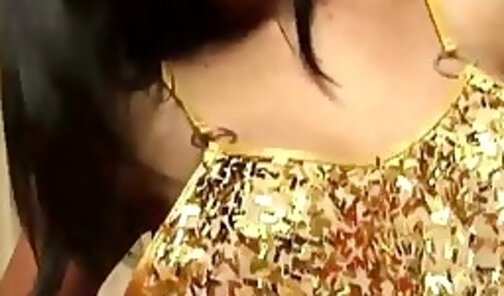 Brunette ladyboy in golden dress teases with her big tits and huge ass